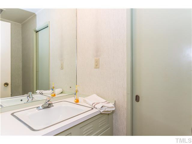 829 Bryan Street Raleigh, NC 27605 - Photo 14 of 23 a bathroom with a sink vanity and a mirror