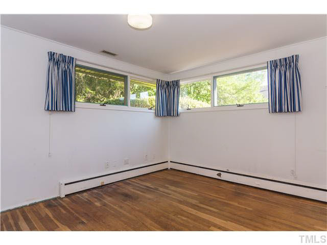 829 Bryan Street Raleigh, NC 27605 - Photo 15 of 23 an empty room with wooden floor and windows