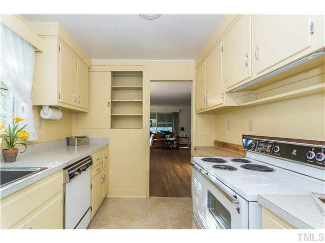 829 Bryan Street Raleigh, NC 27605 - Photo 8 of 23 a kitchen with a sink a stove and cabinets