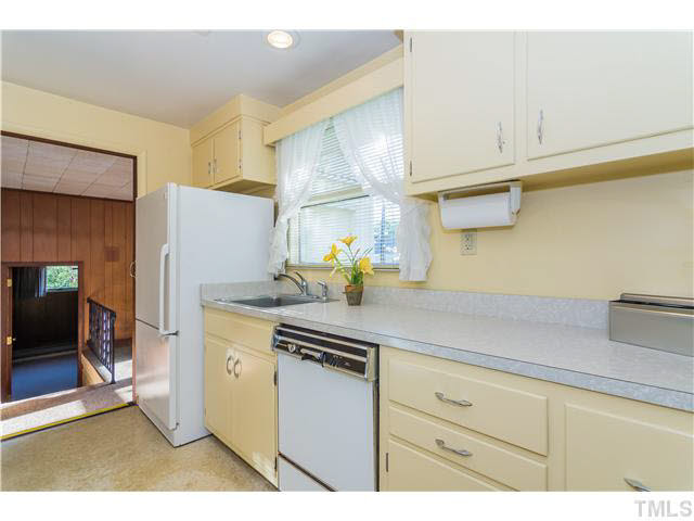 829 Bryan Street Raleigh, NC 27605 - Photo 9 of 23 a kitchen with stainless steel appliances white cabinets and a refrigerator