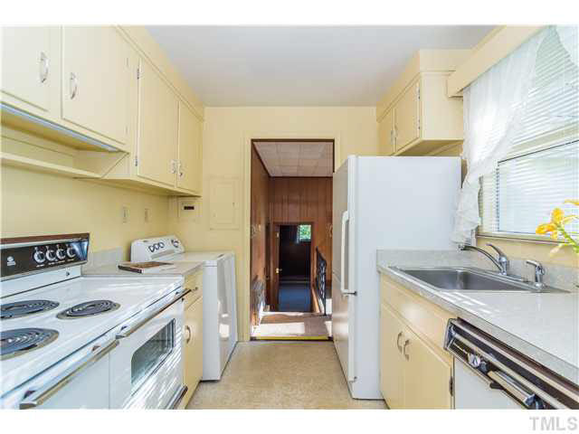 829 Bryan Street Raleigh, NC 27605 - Photo 10 of 23 a kitchen with a sink a stove and cabinets