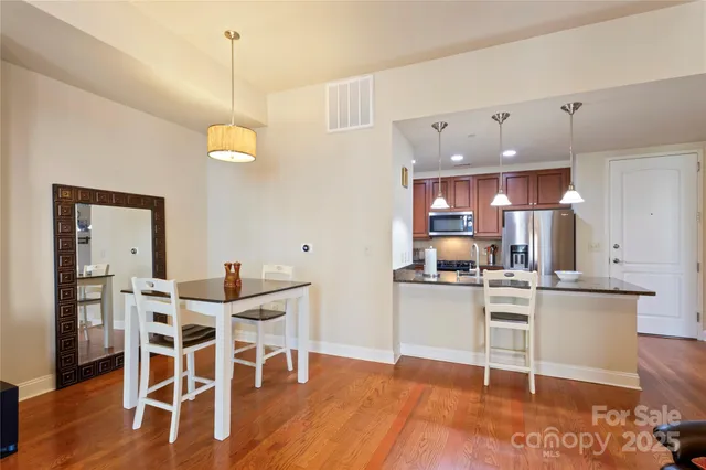a view of a kitchen with dining table and chairs