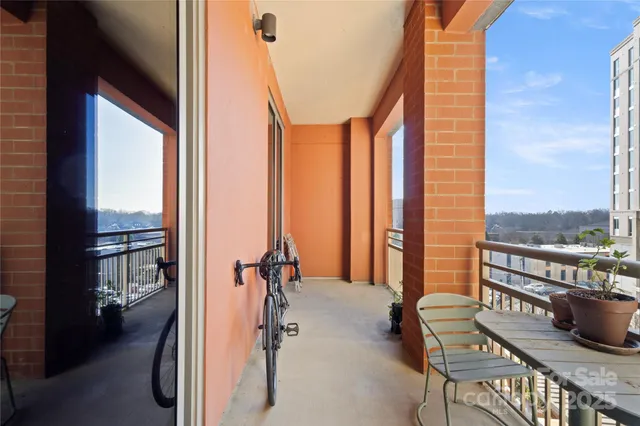 a balcony with hardwood filled with table and chairs