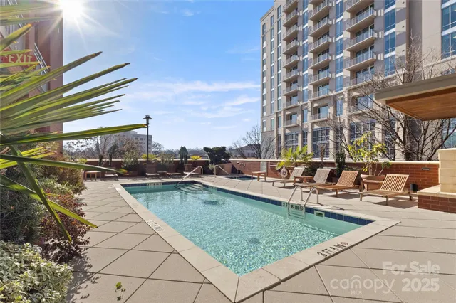 a view of swimming pool with outdoor seating and plants
