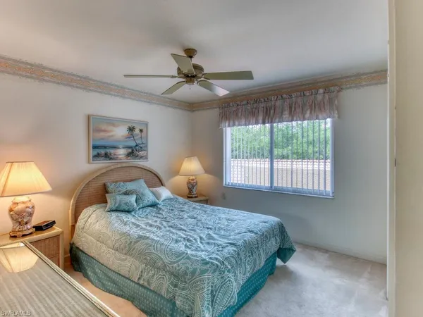 a bedroom with a large bed and a window