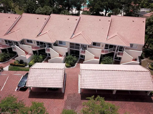 a view of a white house with a yard