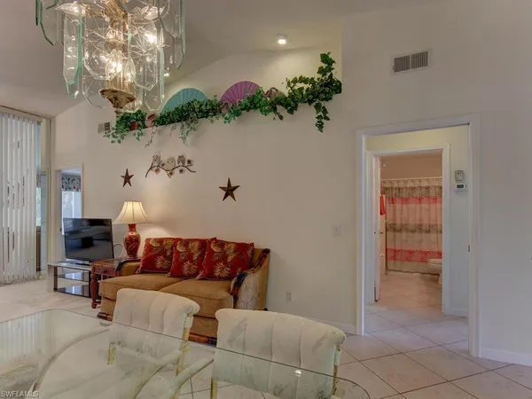 a living room with furniture chandelier and a chandelier