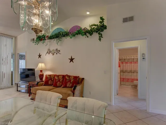 a living room with furniture chandelier and a chandelier