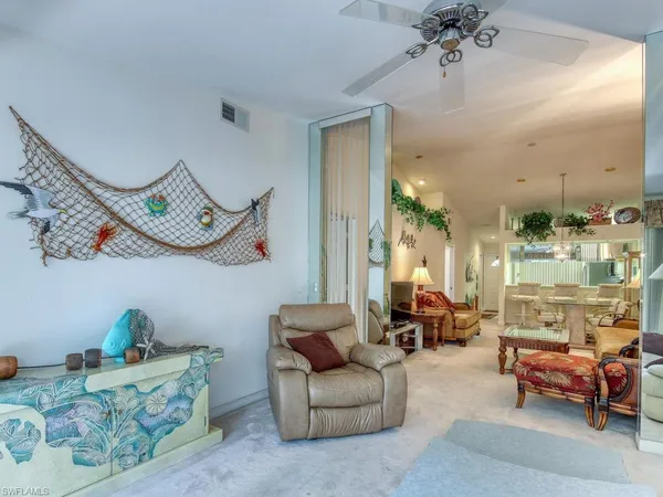 a living room with furniture and a chandelier