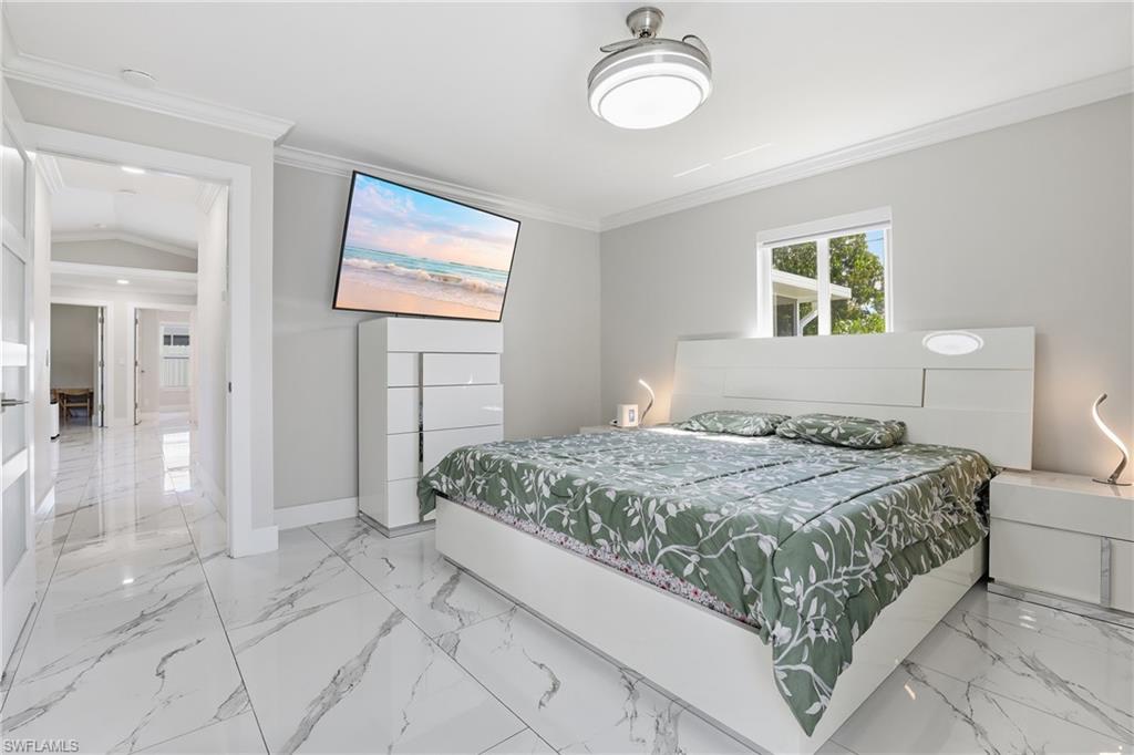 5312 17th Avenue Southwest Naples, FL 34116 - Photo 17 of 45 Bedroom featuring crown molding and light marble finish flooring