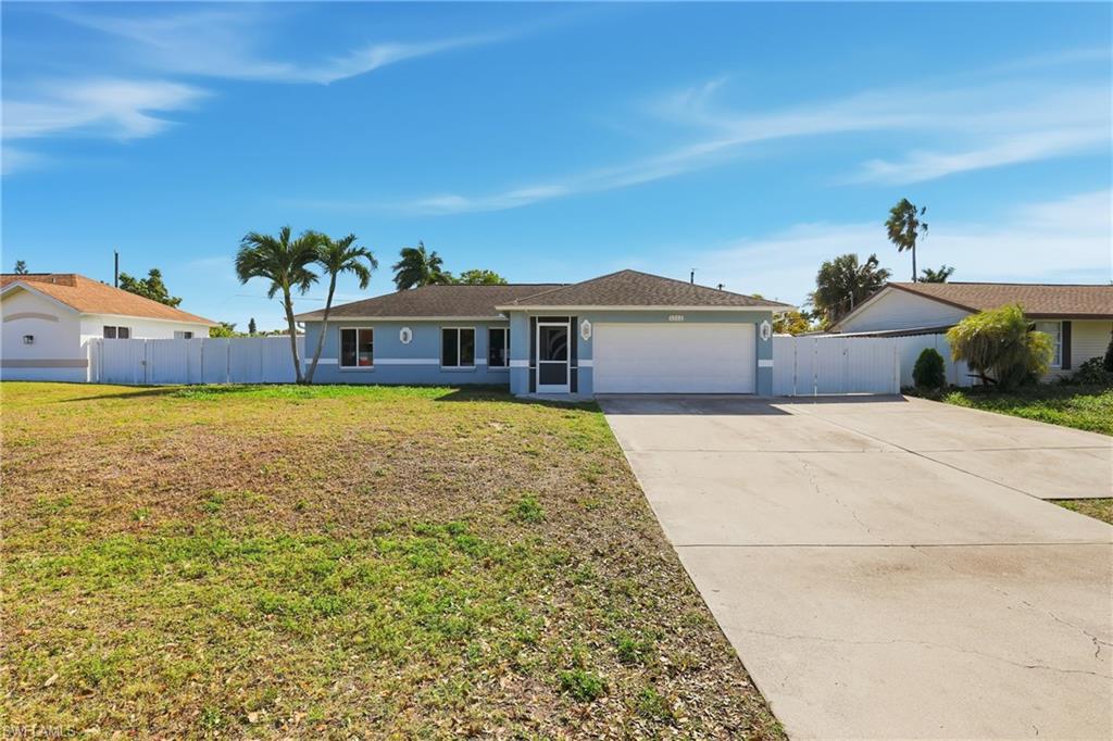5312 17th Avenue Southwest Naples, FL 34116 - Photo 2 of 45 Single story home featuring concrete driveway, stucco siding, a garage, and a gate