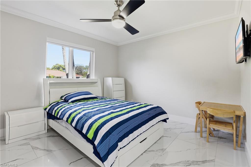 5312 17th Avenue Southwest Naples, FL 34116 - Photo 21 of 45 Bedroom with crown molding and ceiling fan