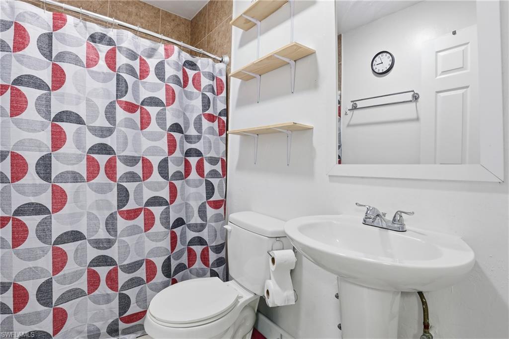 5312 17th Avenue Southwest Naples, FL 34116 - Photo 26 of 45 Bathroom featuring a shower with curtain and toilet