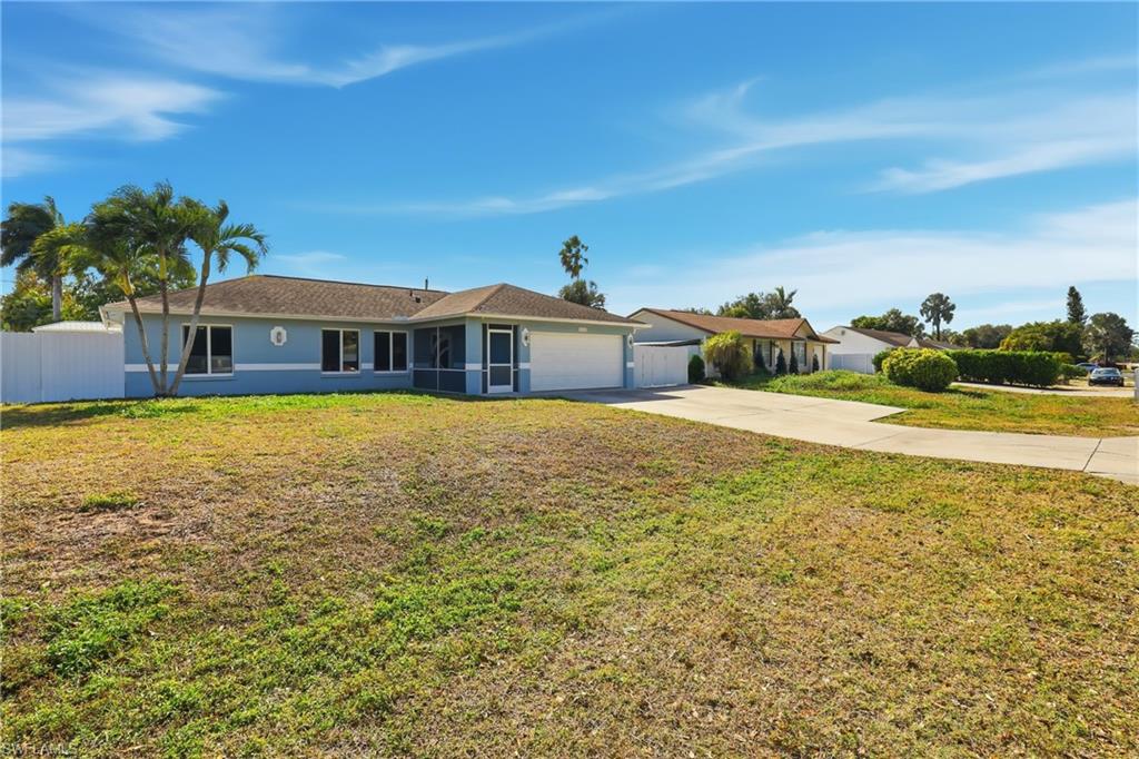 5312 17th Avenue Southwest Naples, FL 34116 - Photo 3 of 45 Single story home with driveway, stucco siding, an attached garage, and a sunroom