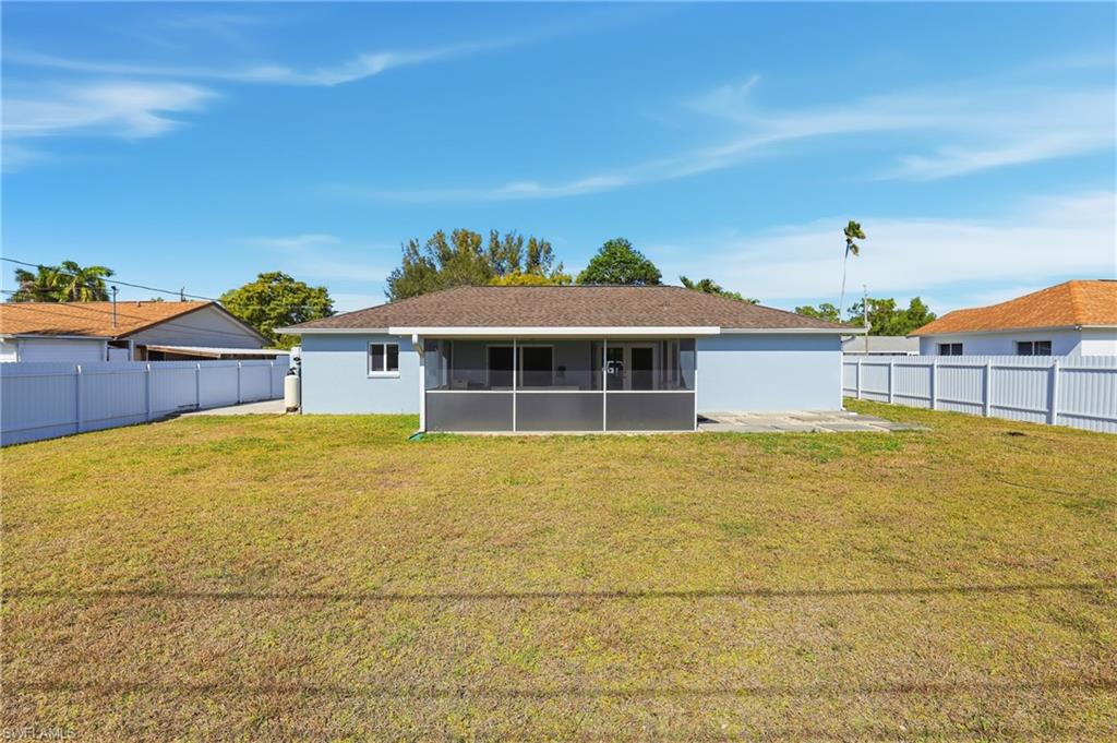 5312 17th Avenue Southwest Naples, FL 34116 - Photo 34 of 45 Back of house with a sunroom, a fenced backyard, and stucco siding