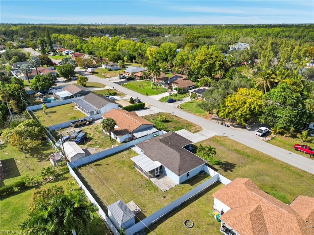 5312 17th Avenue Southwest Naples, FL 34116 - Photo 40 of 45 Aerial view of property's location featuring nearby suburban area and a heavily wooded area