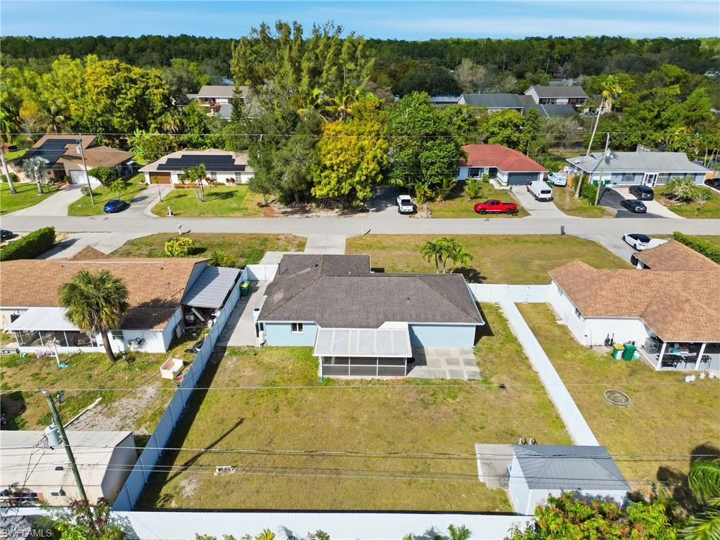 5312 17th Avenue Southwest Naples, FL 34116 - Photo 41 of 45 Aerial perspective of suburban area featuring a forest