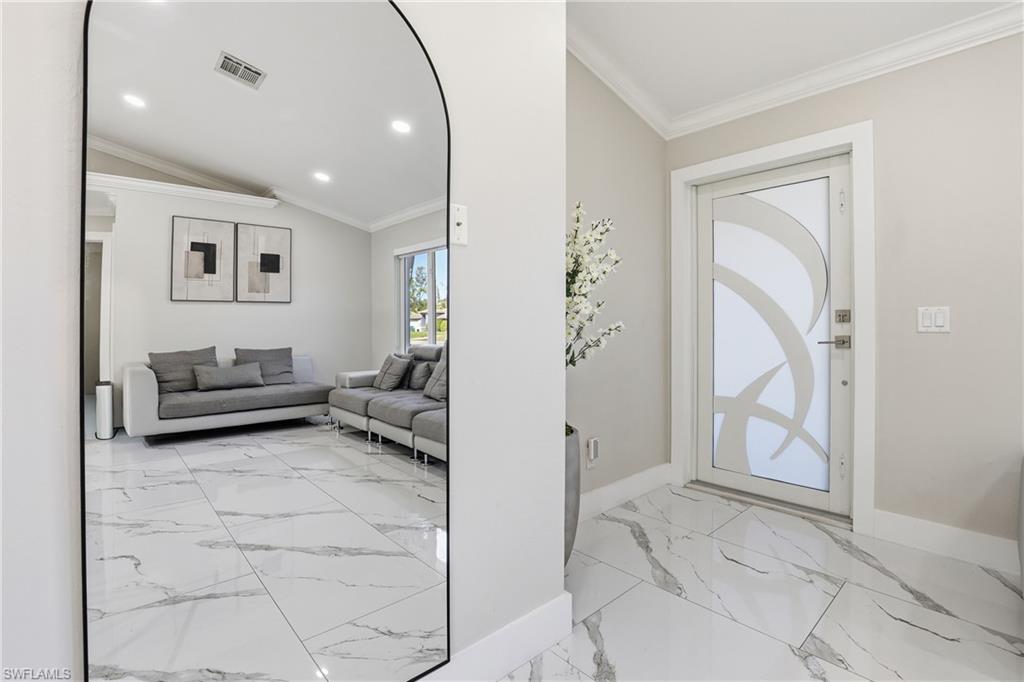 5312 17th Avenue Southwest Naples, FL 34116 - Photo 6 of 45 Entrance foyer with light marble finish floors, ornamental molding, recessed lighting, and vaulted ceiling