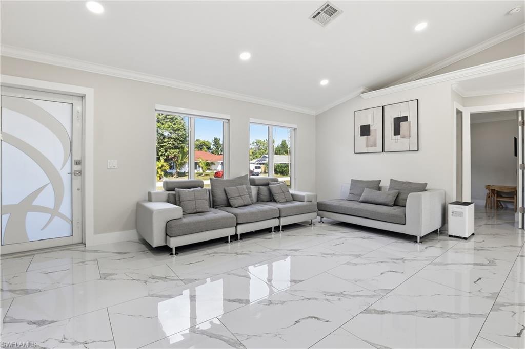 5312 17th Avenue Southwest Naples, FL 34116 - Photo 7 of 45 Living room featuring vaulted ceiling, ornamental molding, and recessed lighting