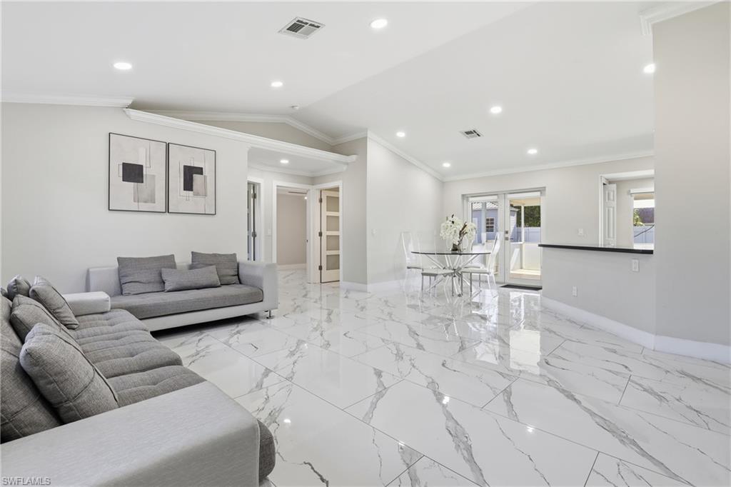 5312 17th Avenue Southwest Naples, FL 34116 - Photo 10 of 45 Living room with ornamental molding, vaulted ceiling, and recessed lighting