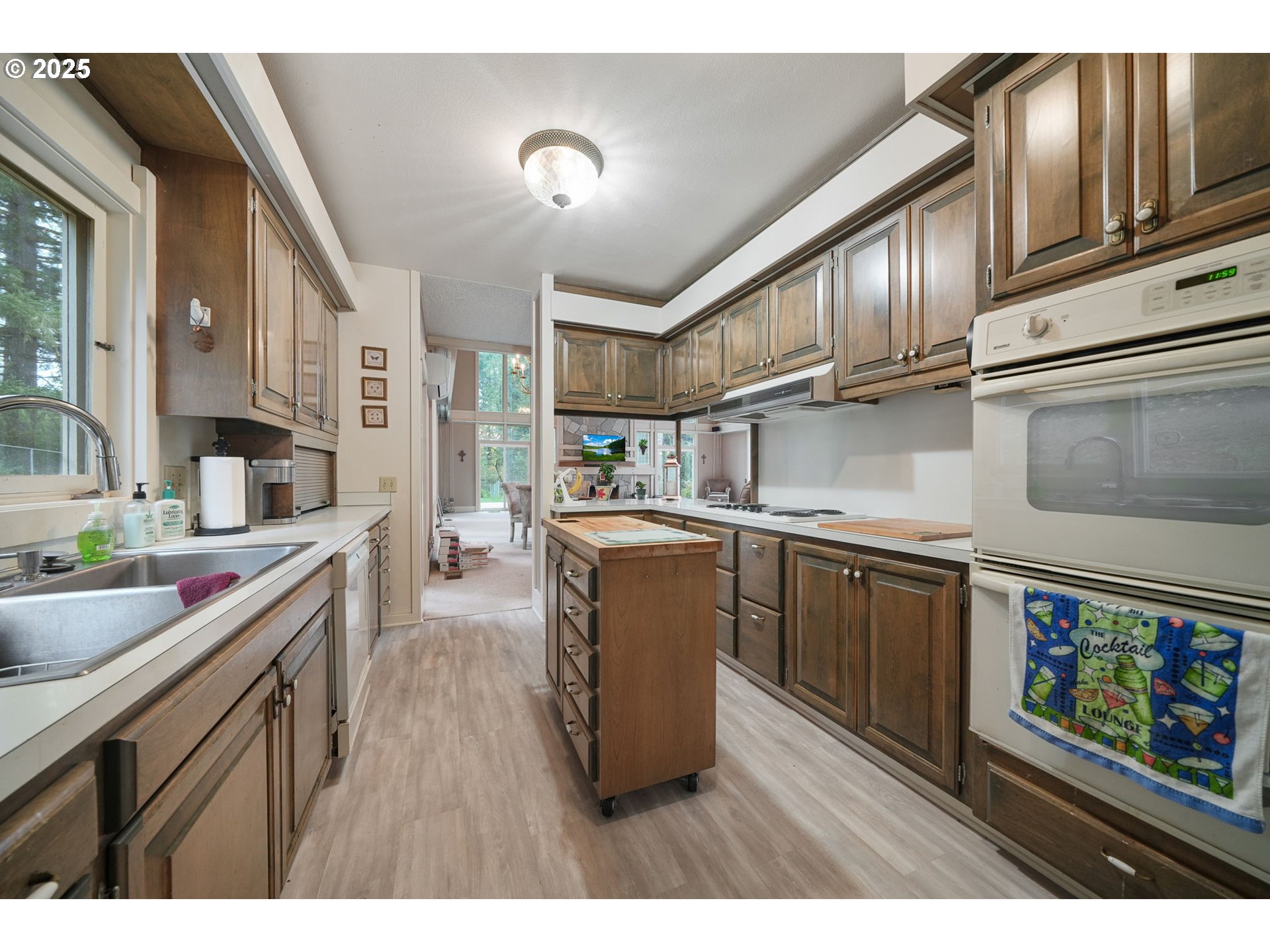27415 Siuslaw Road Lorane, OR 97451 - Photo 12 of 48 a kitchen with stainless steel appliances granite countertop a sink stove and wooden cabinets