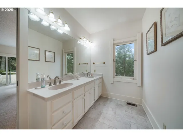 a bathroom with a sink mirror and a shower