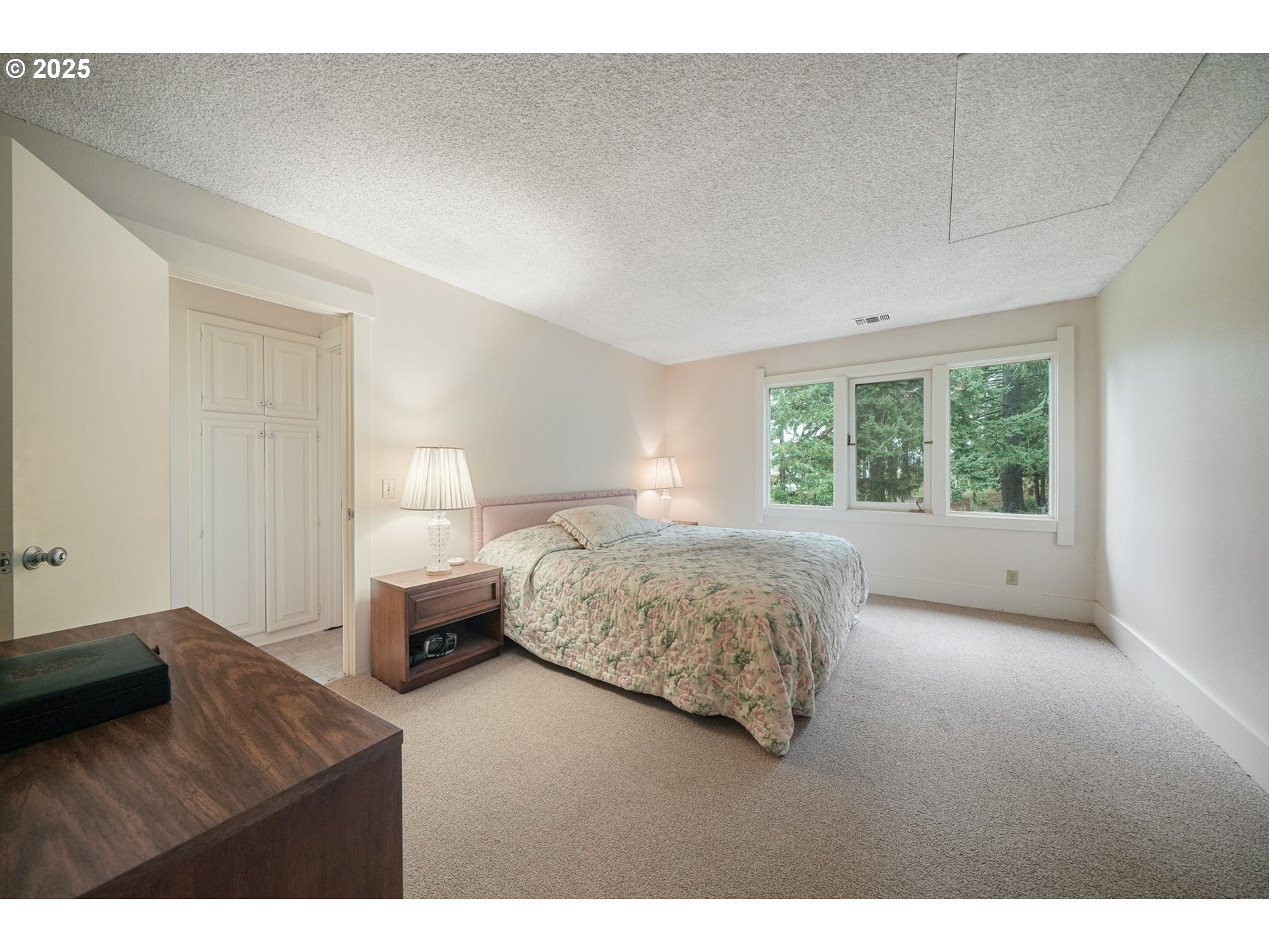 27415 Siuslaw Road Lorane, OR 97451 - Photo 25 of 48 a bedroom with a bed and a large window