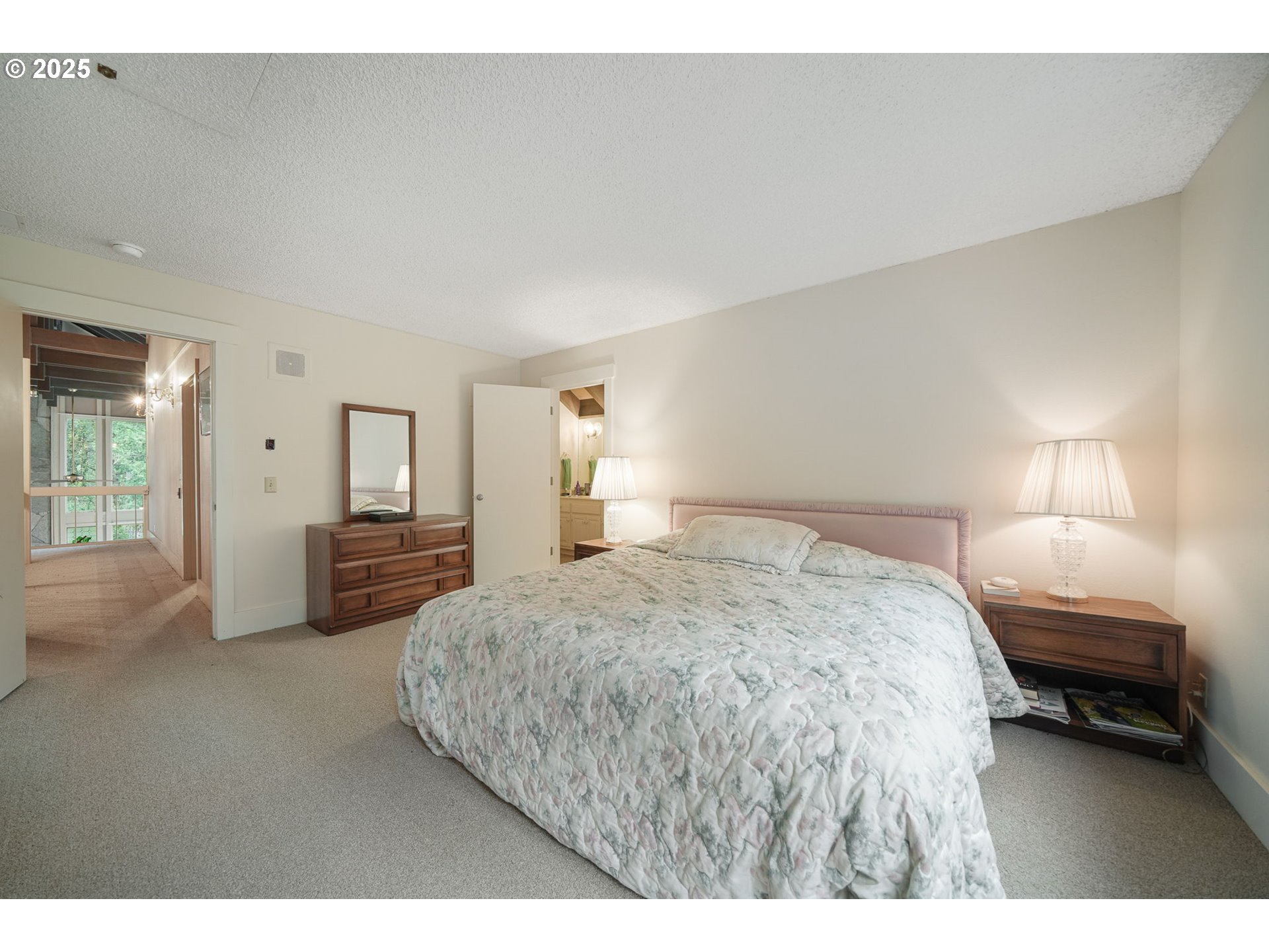 27415 Siuslaw Road Lorane, OR 97451 - Photo 26 of 48 a spacious bedroom with a bed and a cabinets
