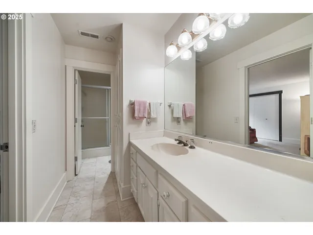 a bedroom with a bed and a lamp on table