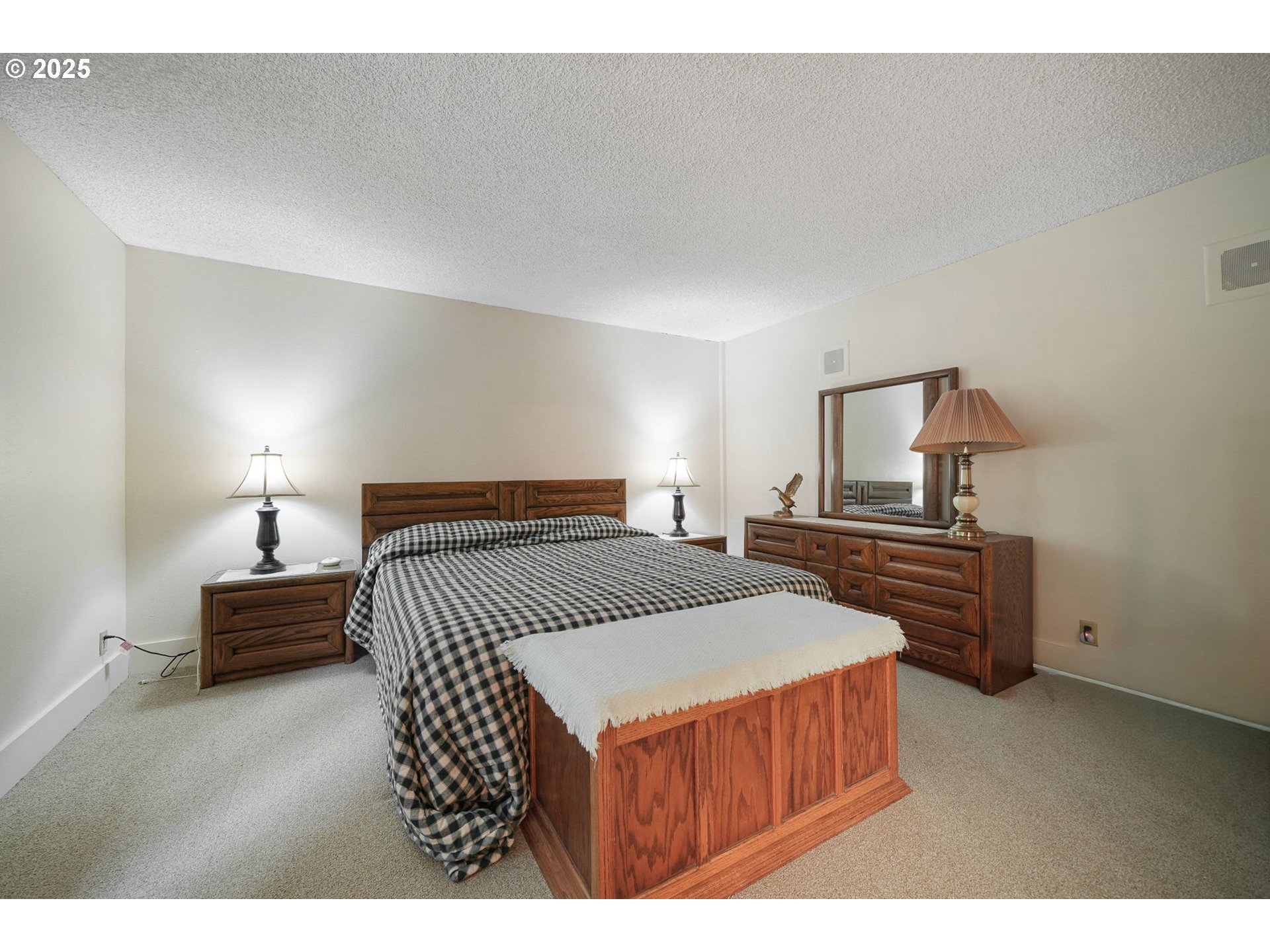 27415 Siuslaw Road Lorane, OR 97451 - Photo 32 of 48 a bedroom with a bed and a lamp on table