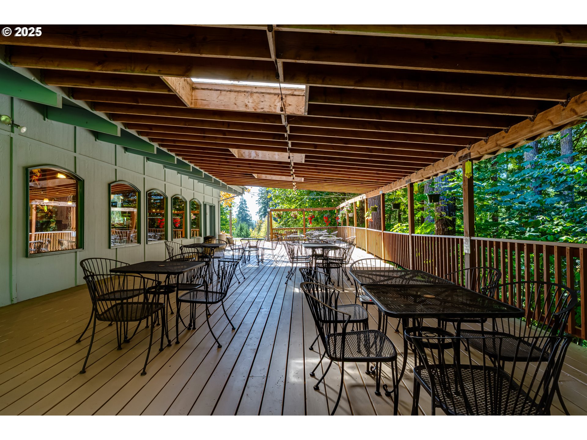 27415 Siuslaw Road Lorane, OR 97451 - Photo 39 of 48 a view of a patio with table and chairs with wooden floor and fence