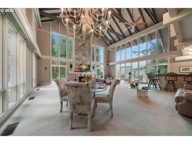 a dining room with furniture and a chandelier