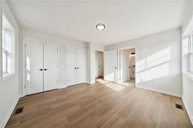 a view of a big room with a ceiling fan and window