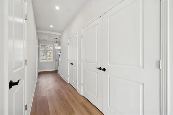 a view of a hallway with wooden floor