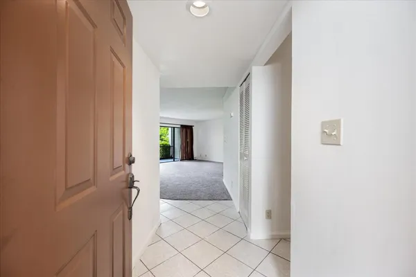 a view of a hallway with wooden shelves