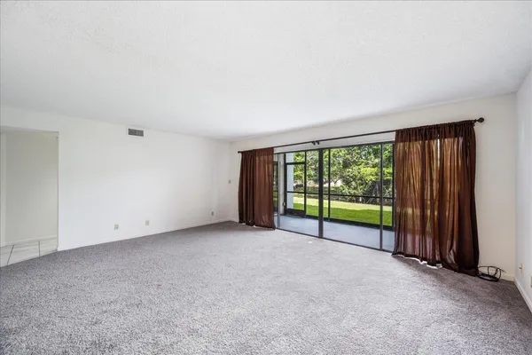 an empty room with large windows