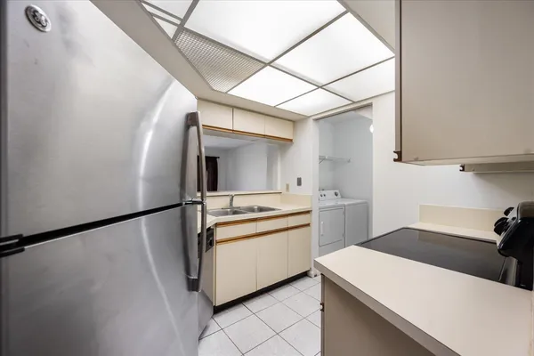 a kitchen with a sink appliances and cabinets