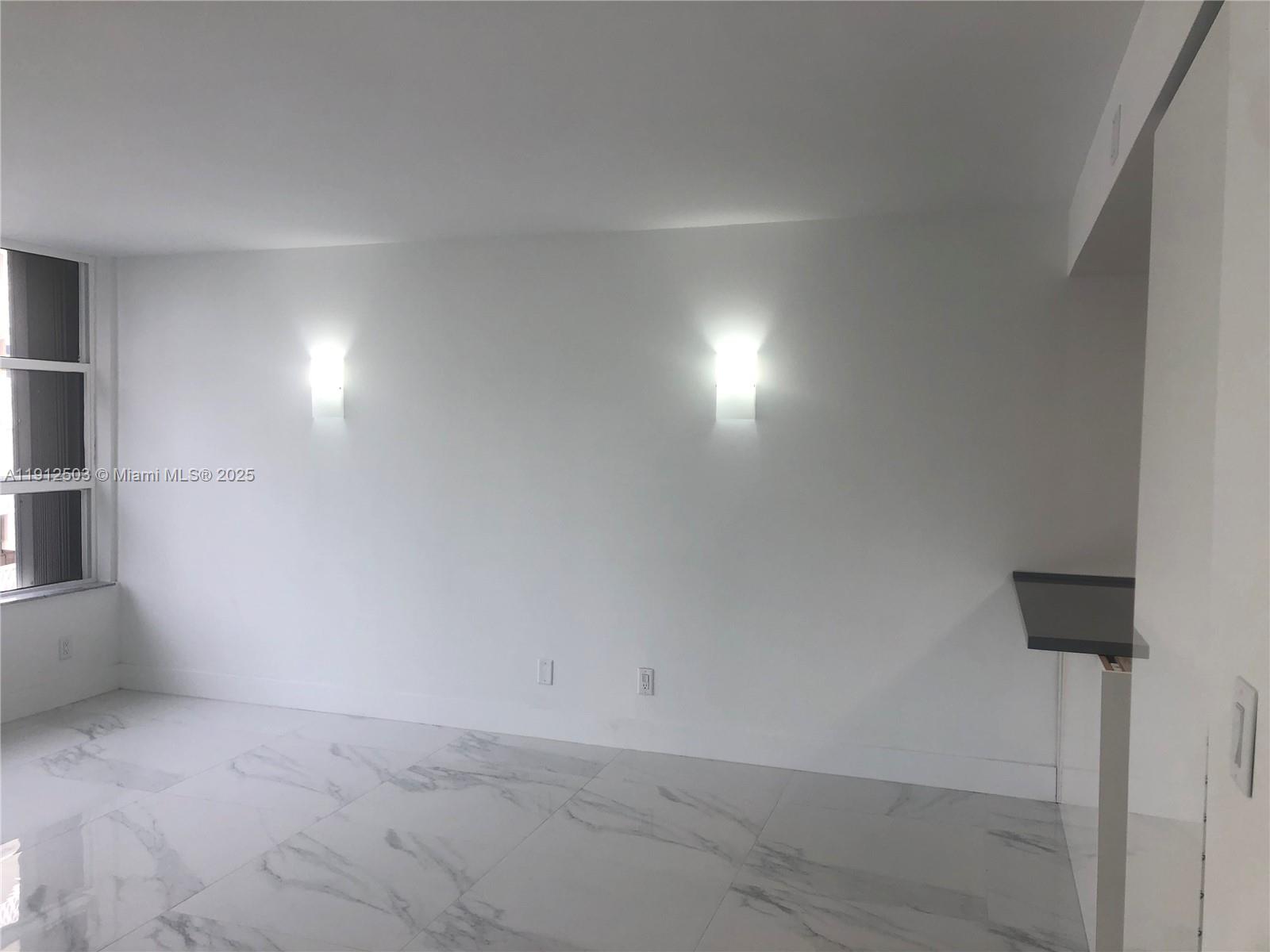 1440 Brickell Bay Drive, Unit 709 Miami, FL 33131 - Photo 5 of 13 a view of room and an empty room