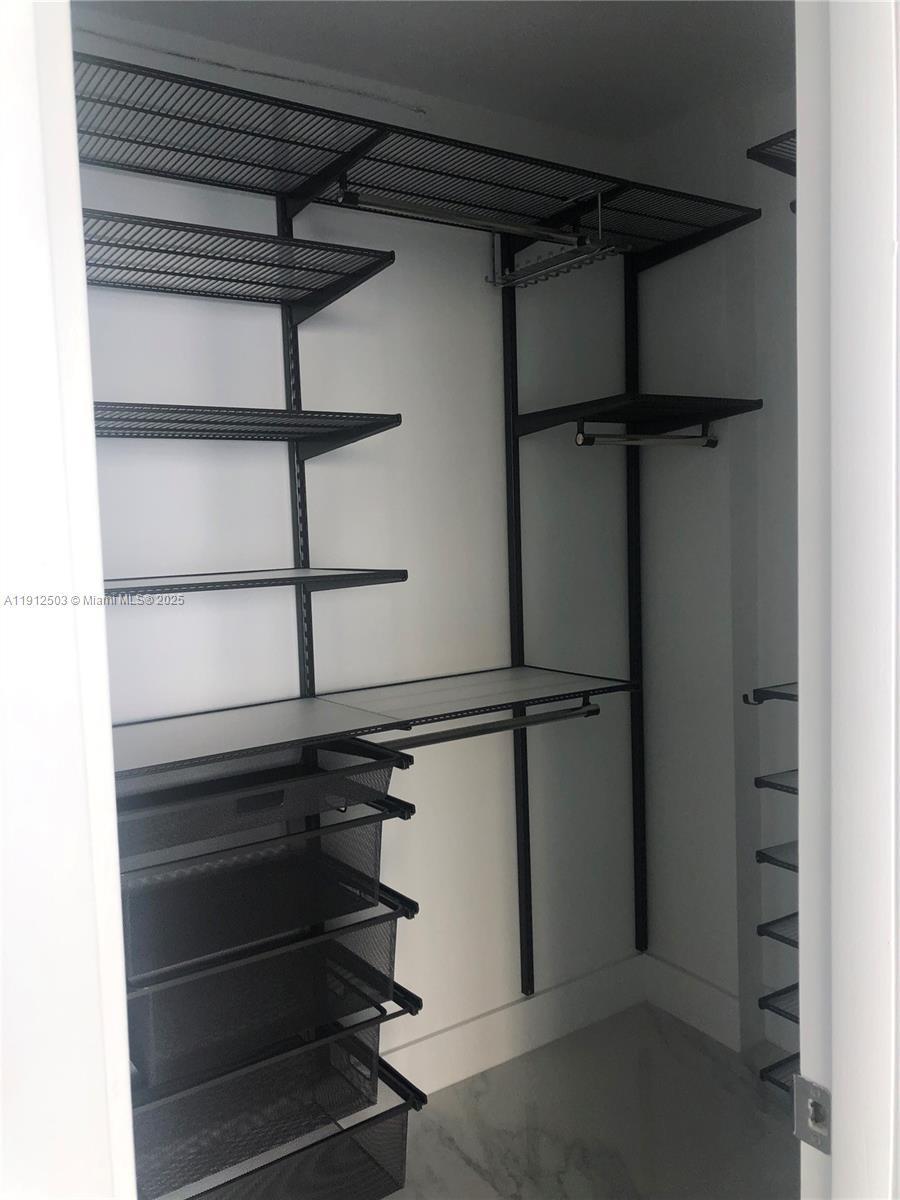 1440 Brickell Bay Drive, Unit 709 Miami, FL 33131 - Photo 8 of 13 a view of a room with shelf on the wall