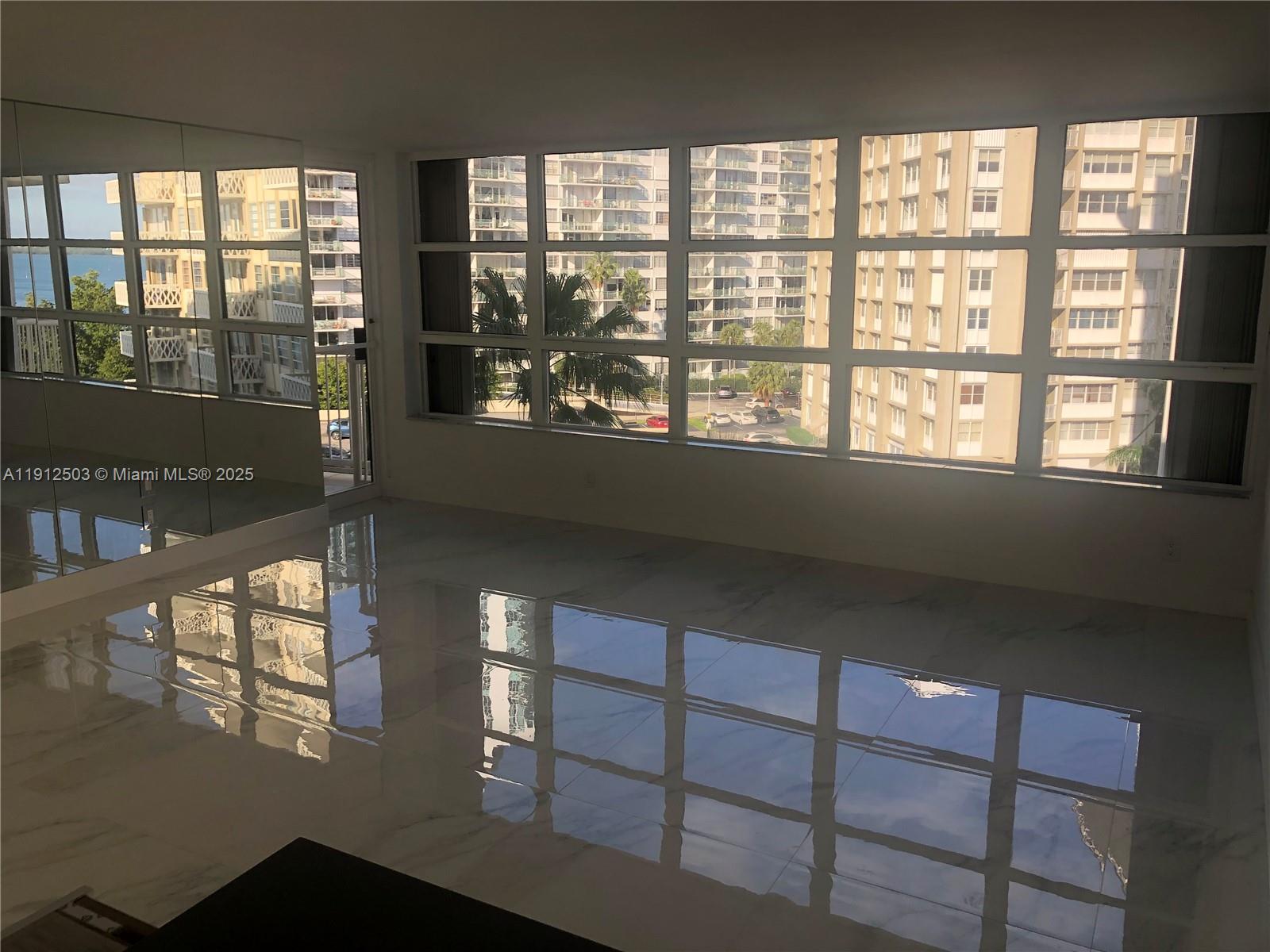 1440 Brickell Bay Drive, Unit 709 Miami, FL 33131 - Photo 9 of 13 a view of an empty room with a window
