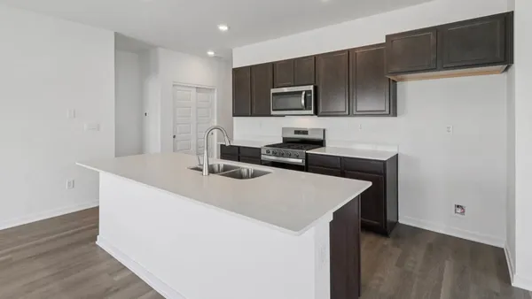 a kitchen that has a sink and a stove in it