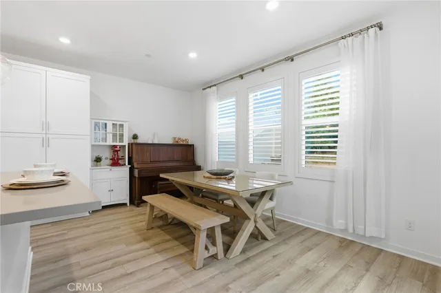 a kitchen with cabinets and wooden floor