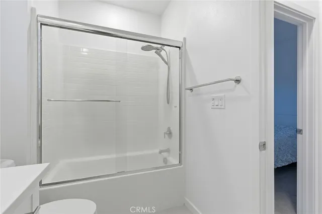 a view of hallway with closet and white walls