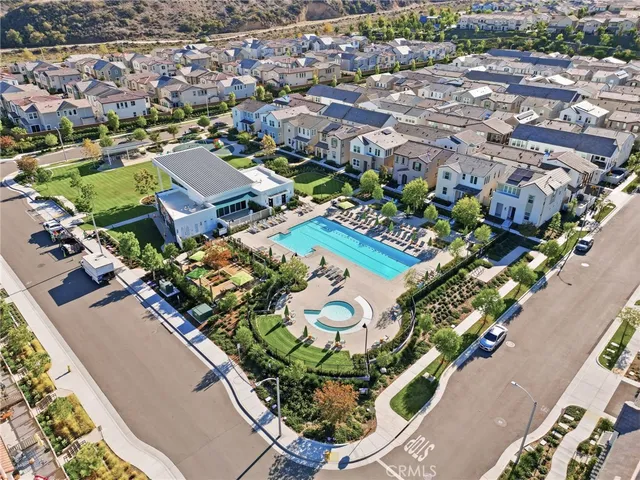 an aerial view of a house with a garden and lake view