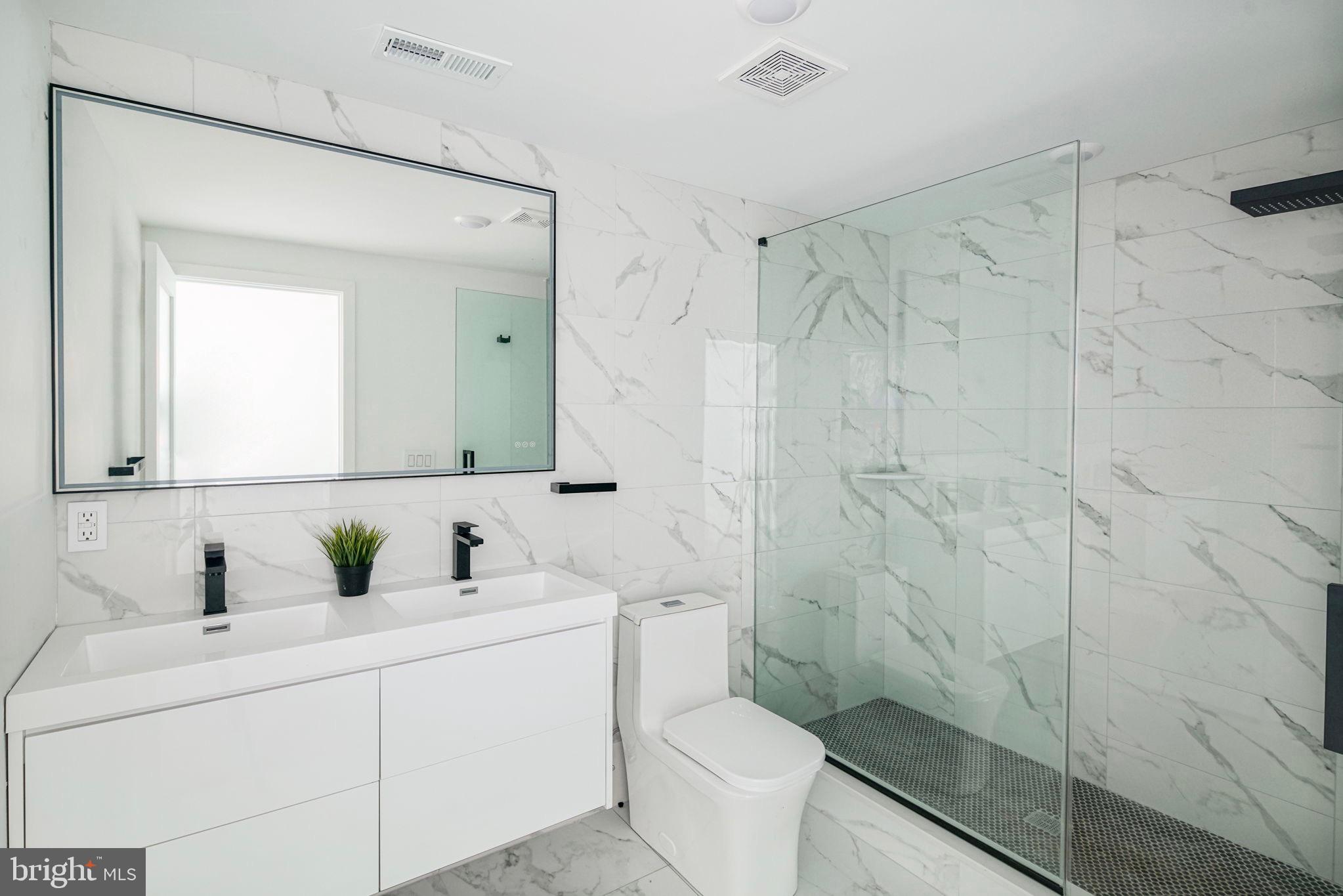 2607 East Boston Street, Unit 2 Philadelphia, PA 19125 - Photo 4 of 18 a bathroom with a sink a toilet and shower