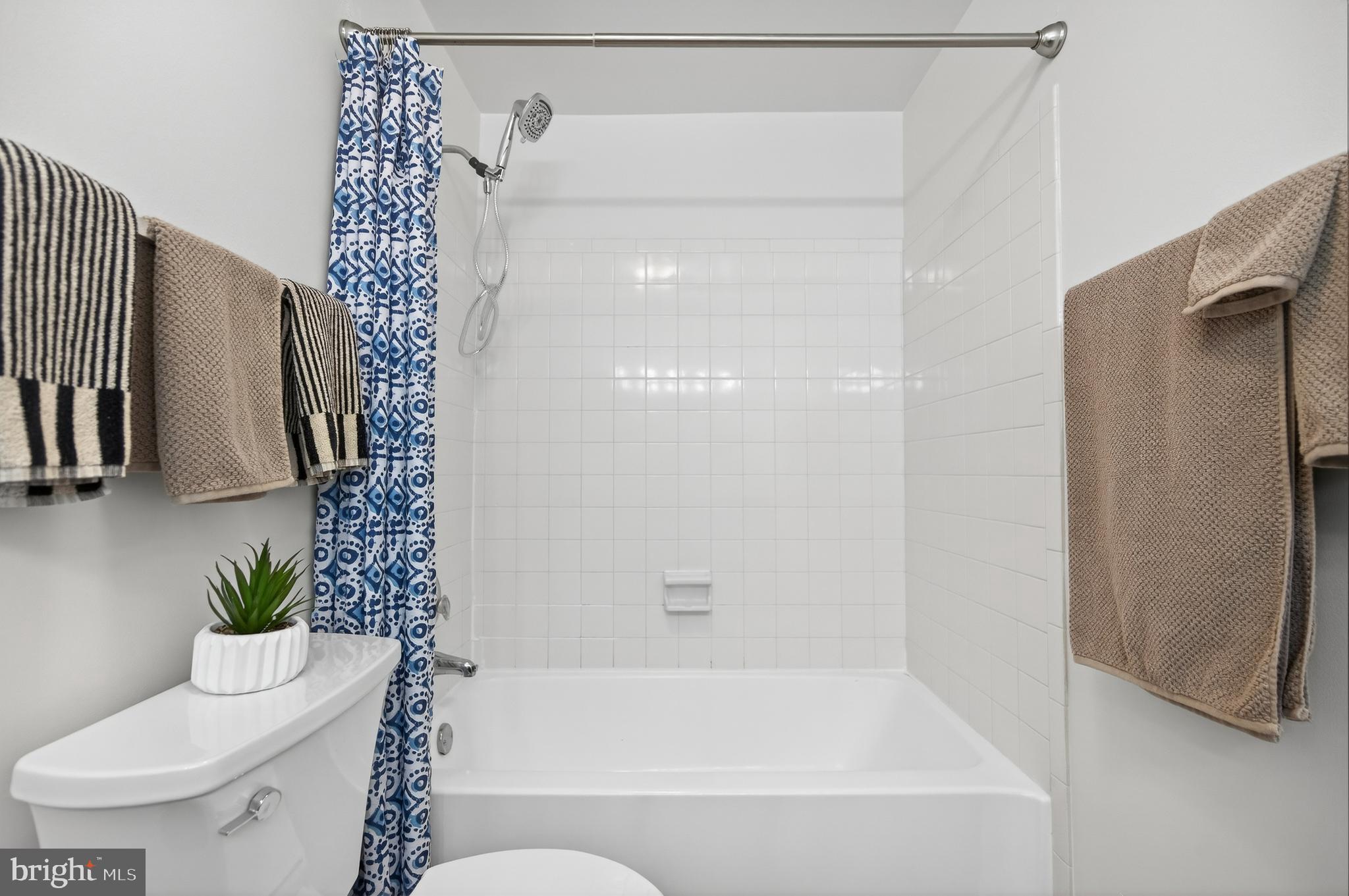 11920 Redtree Way Reston, VA 20194 - Photo 17 of 42 a bathroom with a shower curtain and a toilet