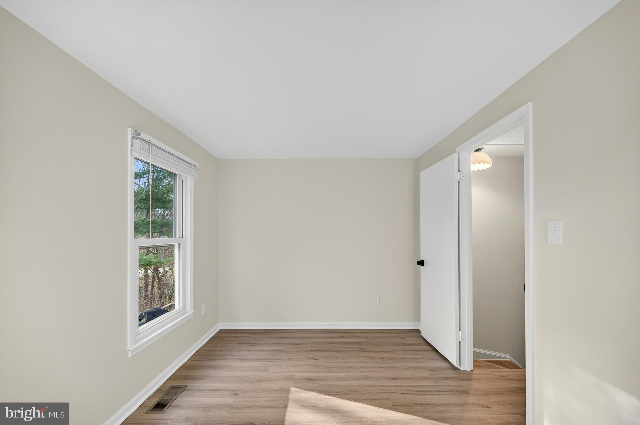 11920 Redtree Way Reston, VA 20194 - Photo 20 of 42 a view of an empty room with wooden floor and a window