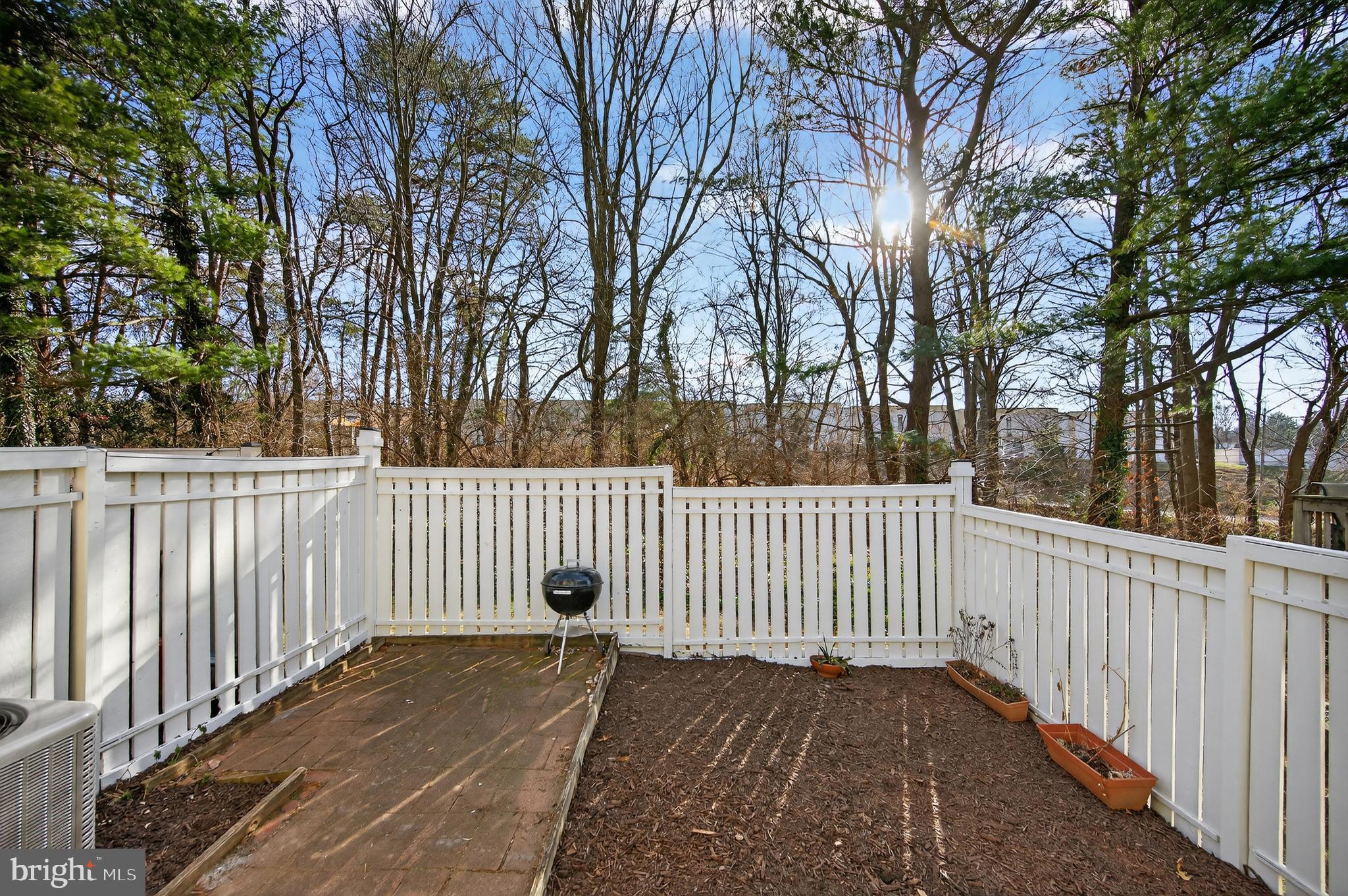 11920 Redtree Way Reston, VA 20194 - Photo 27 of 42 a wooden fence with trees in the back