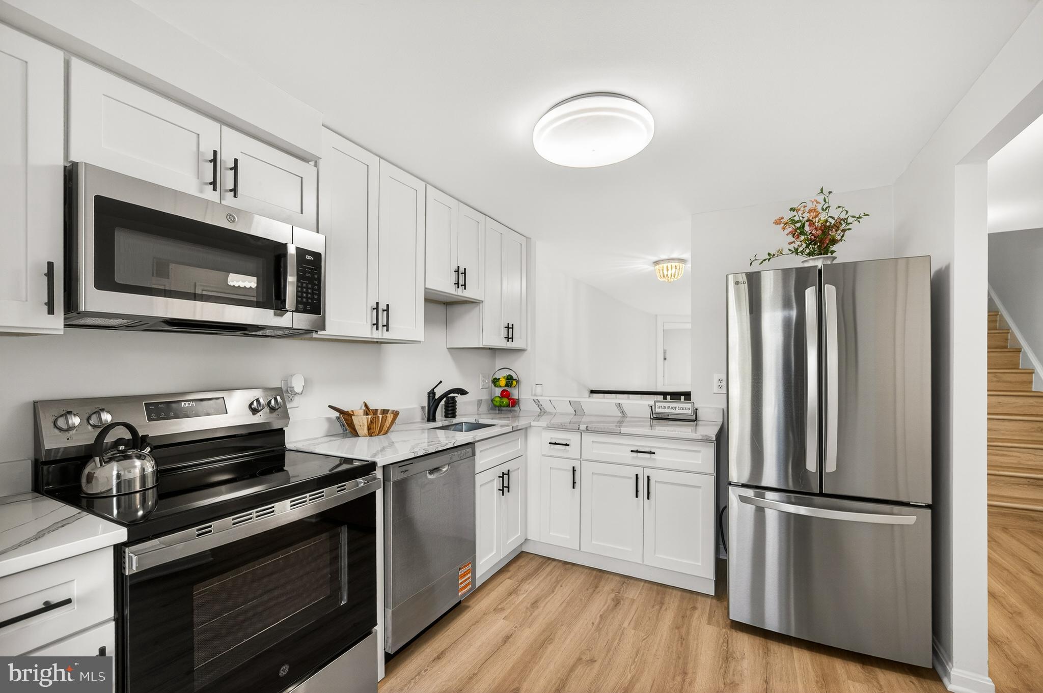 11920 Redtree Way Reston, VA 20194 - Photo 3 of 42 a kitchen with cabinets stainless steel appliances and wooden floor