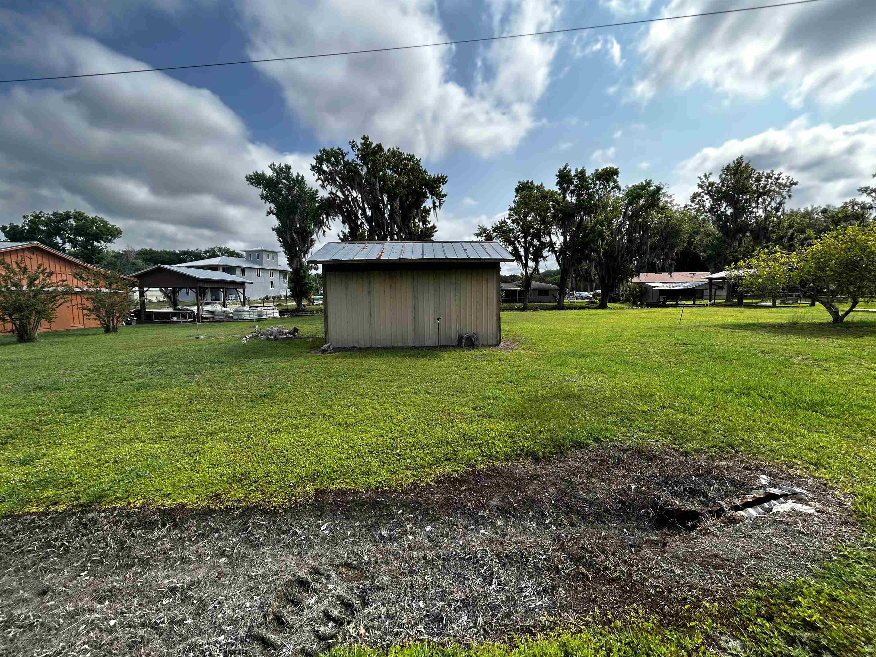 142 Hick's Avenue Crescent City, FL 32112 - Photo 15 of 16 a view of a garden with a bench in the background